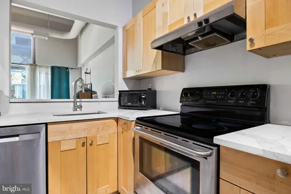 a kitchen with stainless steel appliances granite countertop a stove and a microwave