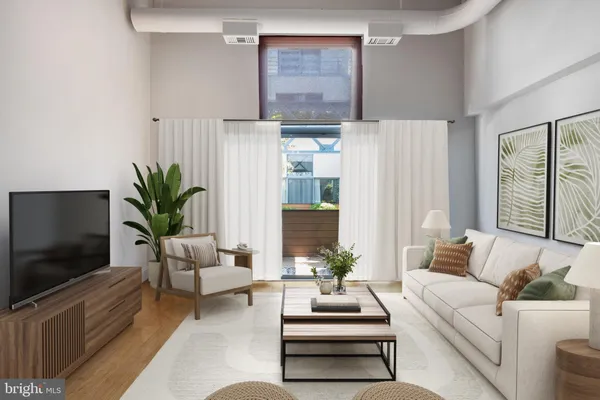 a living room with furniture a large window and a flat screen tv