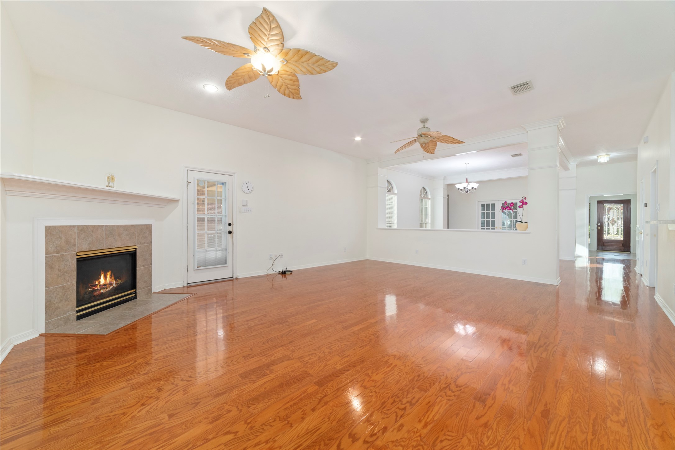 11108 Dawson Road Pearland, TX 77584 - Photo 25 of 43 a view of an empty room with a fireplace and fan