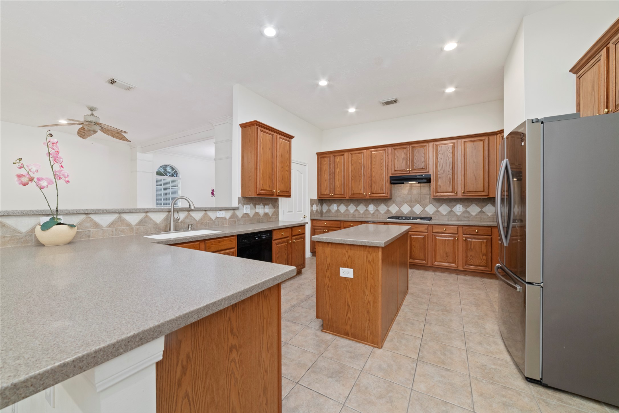 11108 Dawson Road Pearland, TX 77584 - Photo 29 of 43 a kitchen with stainless steel appliances granite countertop a sink refrigerator and cabinets