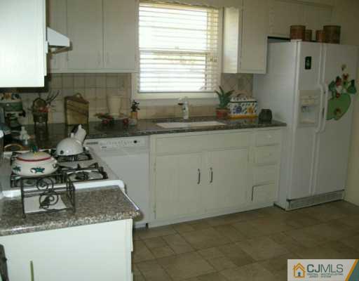 2 Michael Court Old Bridge, NJ 08857 - Photo 4 of 8 a kitchen with a sink a stove cabinets and a window