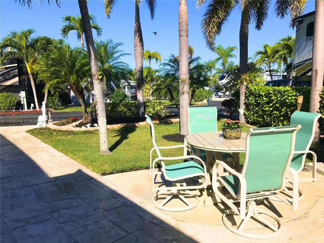 a front view of a house with outdoor seating