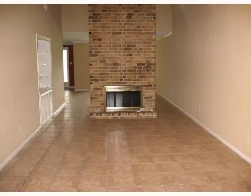 a view of empty room with fireplace