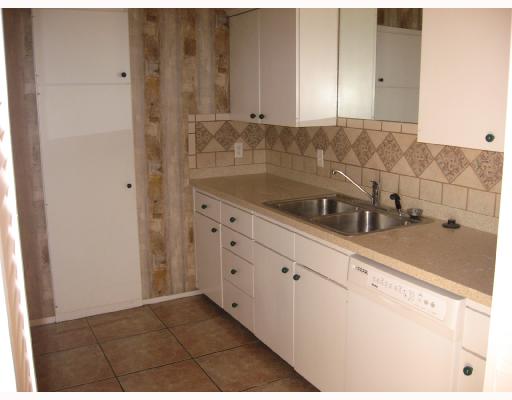 5418 Stonegate Way Corpus Christi, TX 78411 - Photo 3 of 3 a kitchen with granite countertop white cabinets and sink