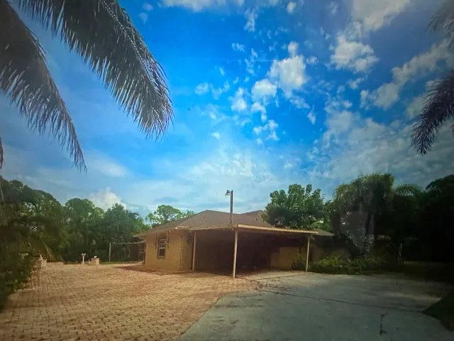 a view of a chair and table in the garden
