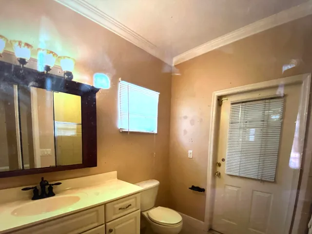 a bathroom with a sink a toilet and mirror