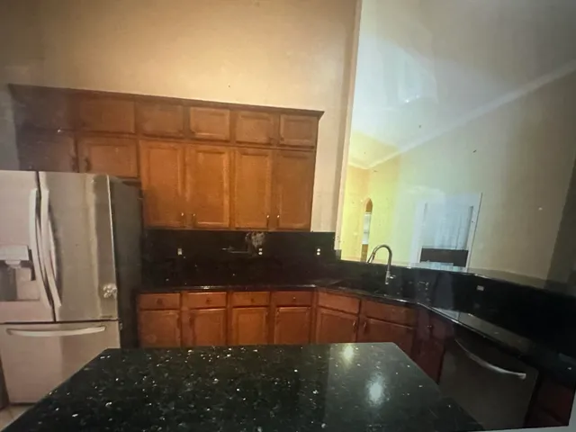 a kitchen with stainless steel appliances a refrigerator and a sink