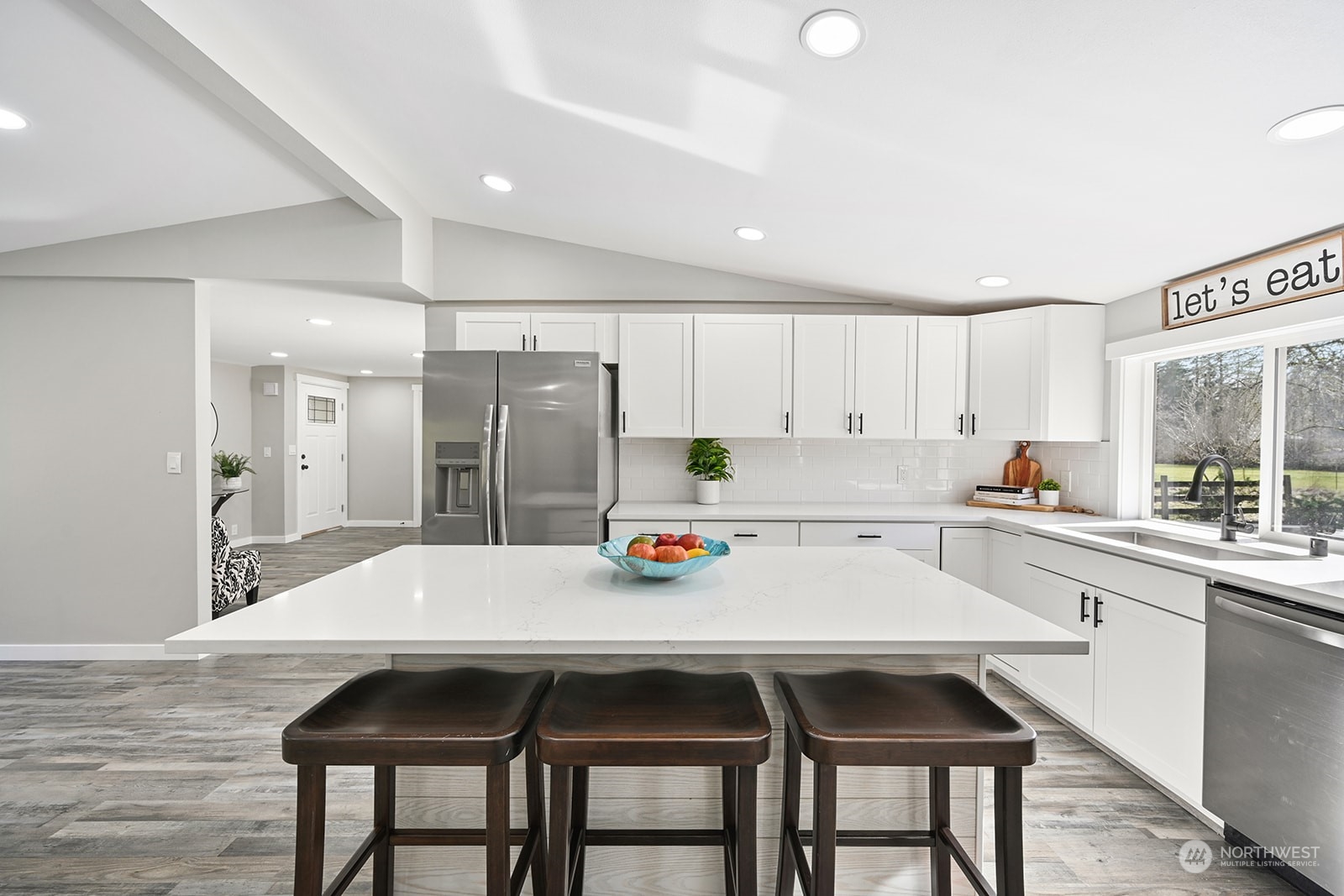 10841 Highway 12 Rochester, WA 98579 - Photo 12 of 23 a kitchen with a dining table chairs refrigerator and cabinets