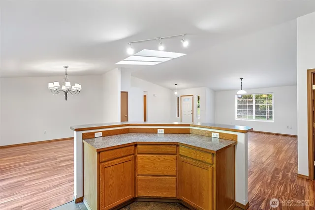 a view of a kitchen counter space and wooden floor