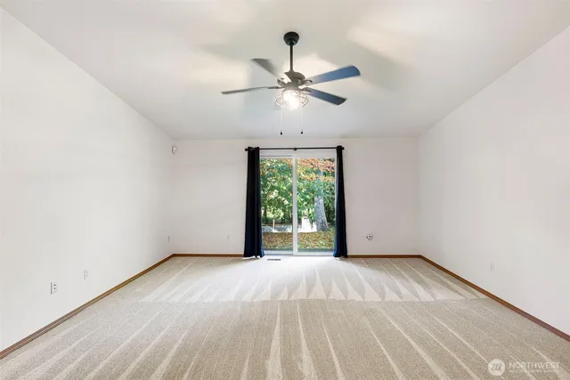a view of room with window and ceiling fan