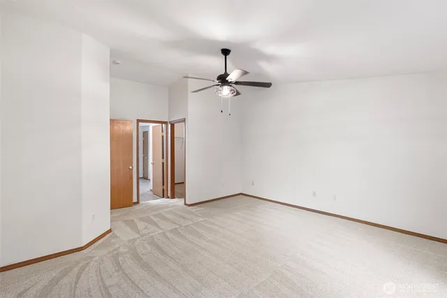a view of a livingroom with a chandelier fan