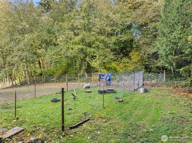 a backyard of a house with table and chairs