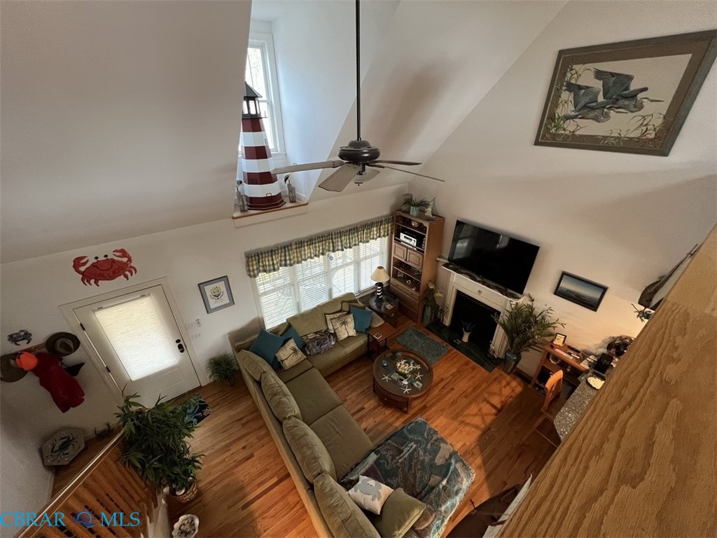 301 Gillim Road Deltaville, VA 23043 - Photo 11 of 31 Living room with a high ceiling, a fireplace, wood finished floors, and ceiling fan