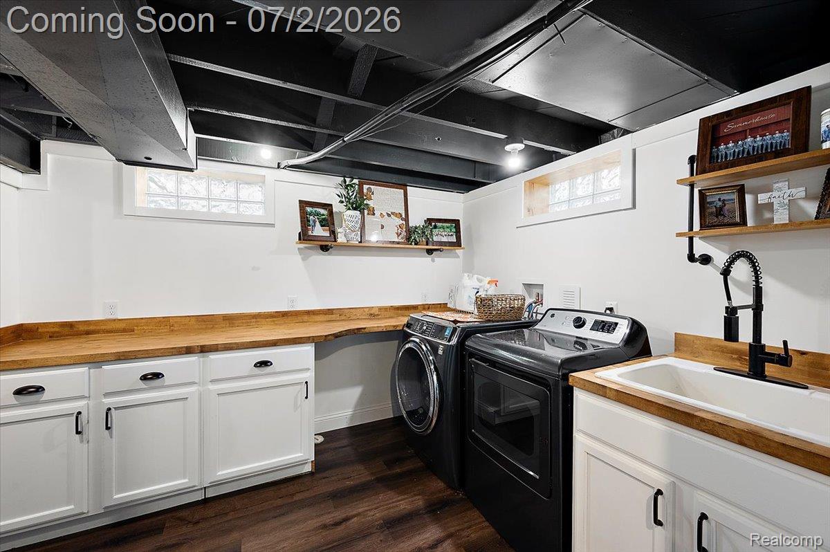 1706 Princeton Road Berkley, MI 48072 - Photo 35 of 49 Laundry room featuring wood-finish flooring, white cabinetry with black hardware, wood-finish countertops, a utility sink with a matte black faucet, and glass block windows