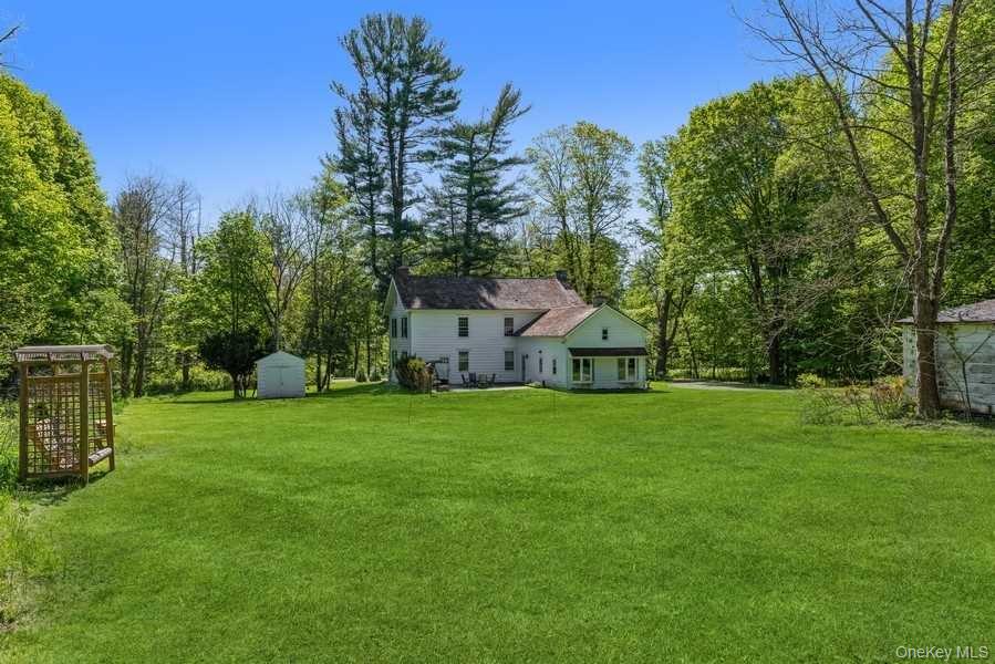 1141 Beekman Road Hopewell Junction, NY 12533 - Photo 32 of 36 a house with a big yard and large trees