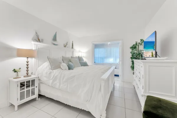 a spacious bedroom with a bed and a couch