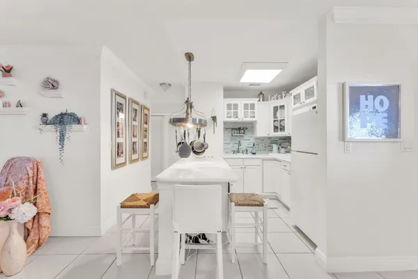 a kitchen with cabinets and chairs