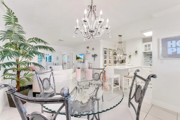 a view of a dining room with furniture and chandelier