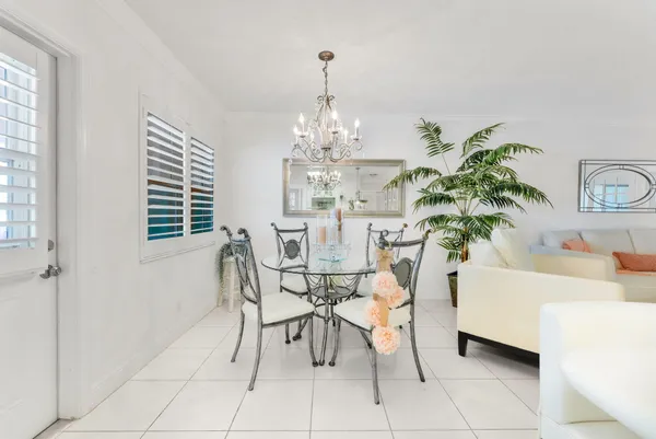 a view of a dining room with furniture and a chandelier