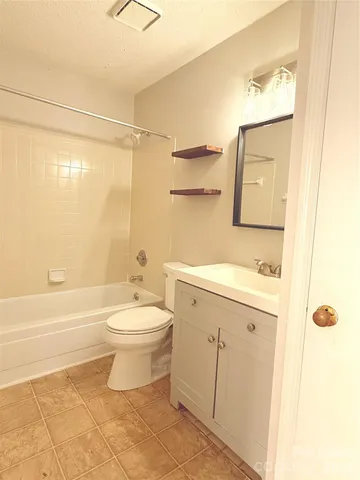 a bathroom with a toilet a sink and bathtub