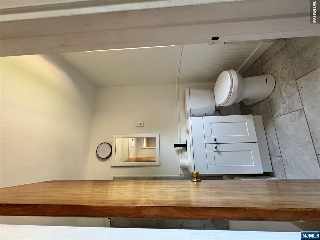 251 Fort Lee Road, Unit D Teaneck, NJ 07666 - Photo 8 of 14 a bathroom with a toilet sink and mirror