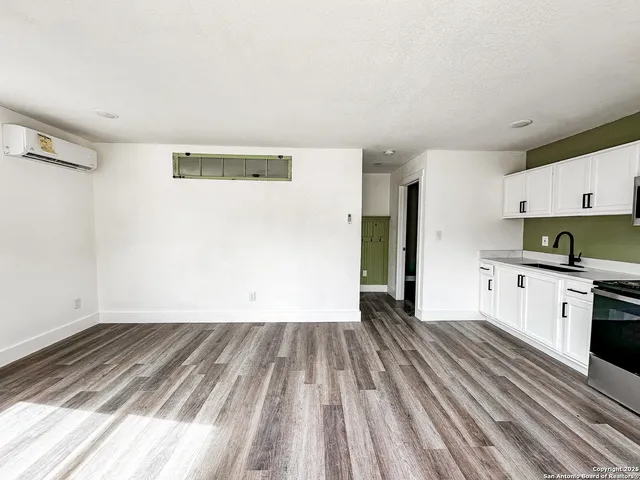 a view of kitchen with sink and refrigerator