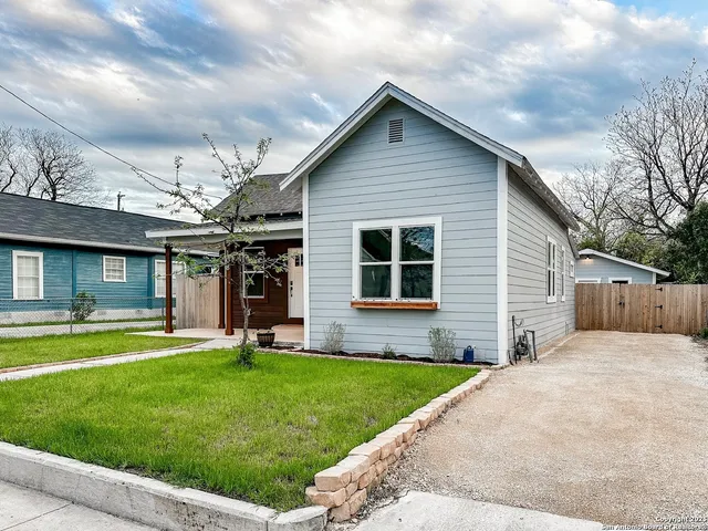 a view of a house with a yard and porch