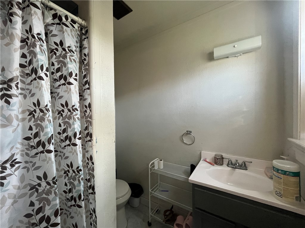 1453 14th Street Corpus Christi, TX 78404 - Photo 14 of 23 a bathroom with a sink toilet and shower