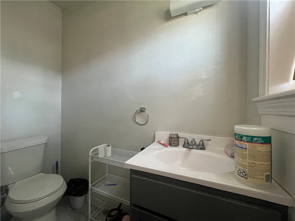1453 14th Street Corpus Christi, TX 78404 - Photo 15 of 23 a bathroom with a sink toilet and a mirror