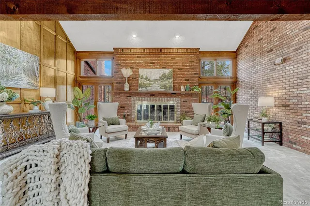 a living room with fireplace furniture and a floor to ceiling window