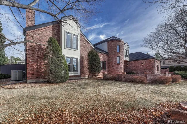 a view of a brick building next to a yard
