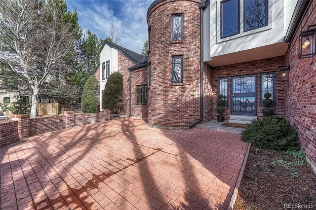a view of a brick building next to a yard