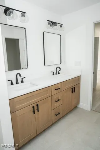 a bathroom with a double vanity sink and mirror
