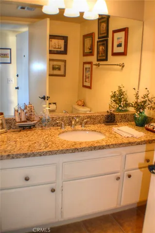 a view of a kitchen with granite countertop cabinets