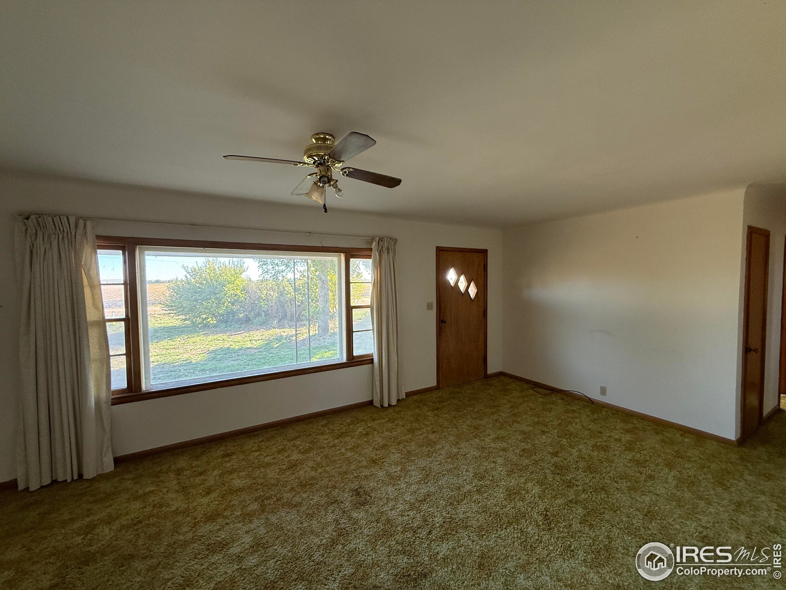 31123 County Road West Brush, CO 80723 - Photo 5 of 11 an empty room with windows and mountain view