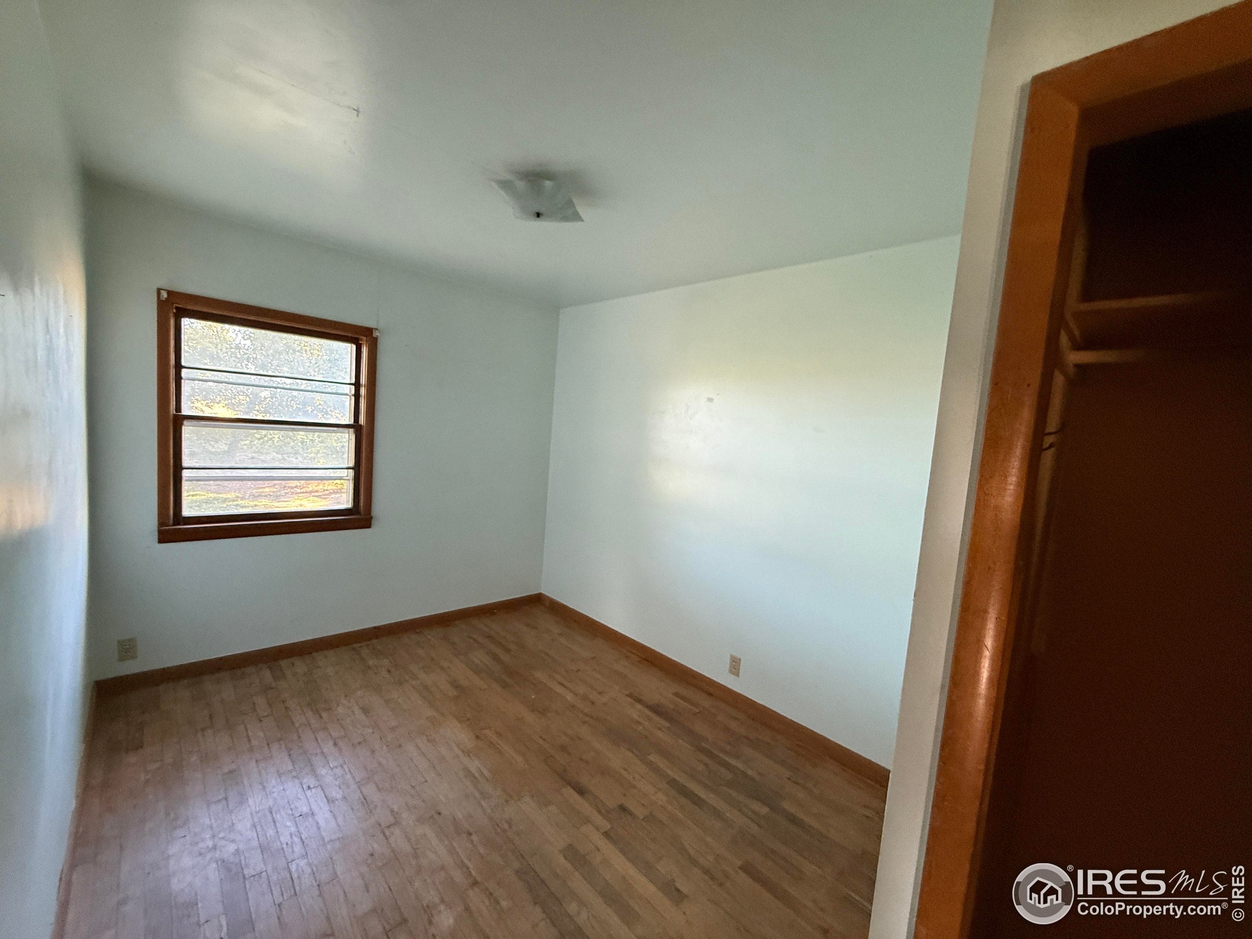 31123 County Road West Brush, CO 80723 - Photo 10 of 11 an empty room with wooden floor and windows