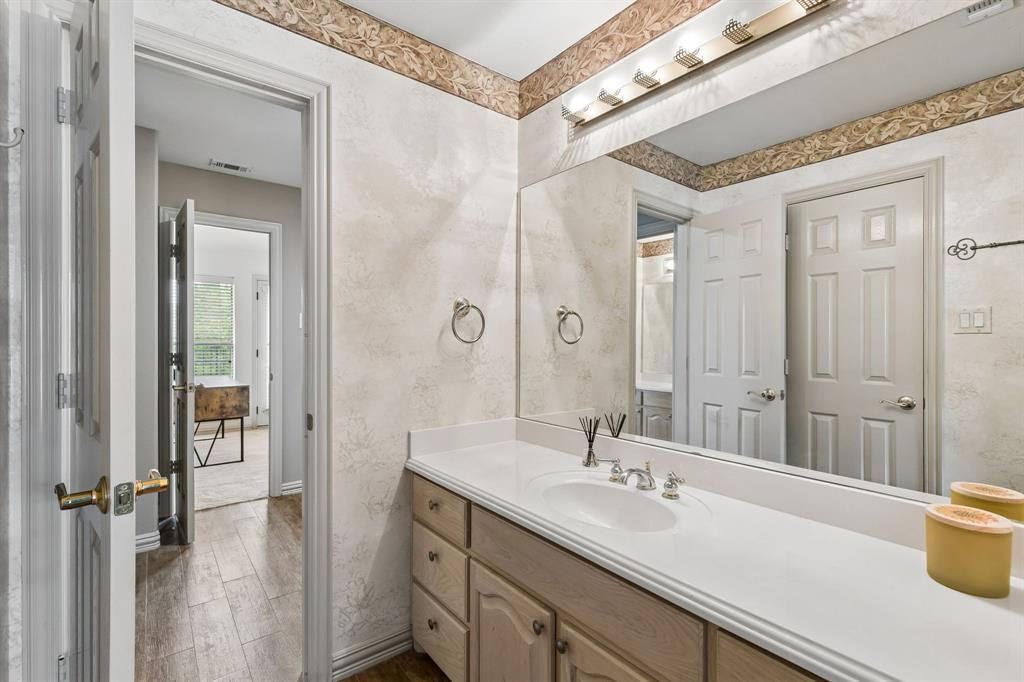 8517 Navigation Drive Rowlett, TX 75088 - Photo 35 of 39 a bathroom with a sink and a mirror with bathtub