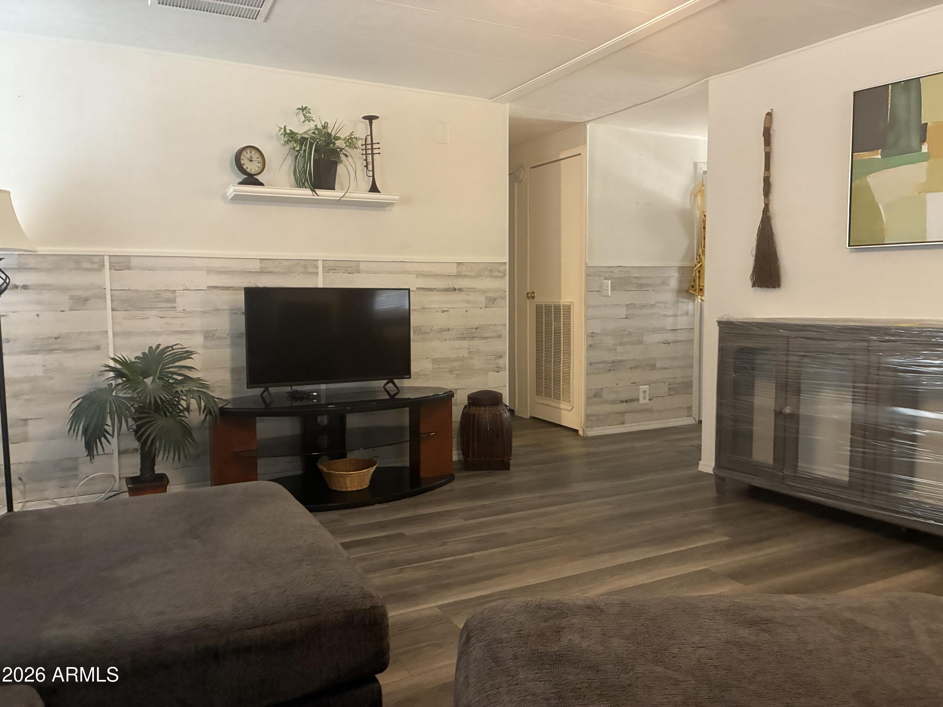 53 North Mountain Road, Unit 58 Apache Junction, AZ 85120 - Photo 3 of 39 a living room with furniture and a flat screen tv