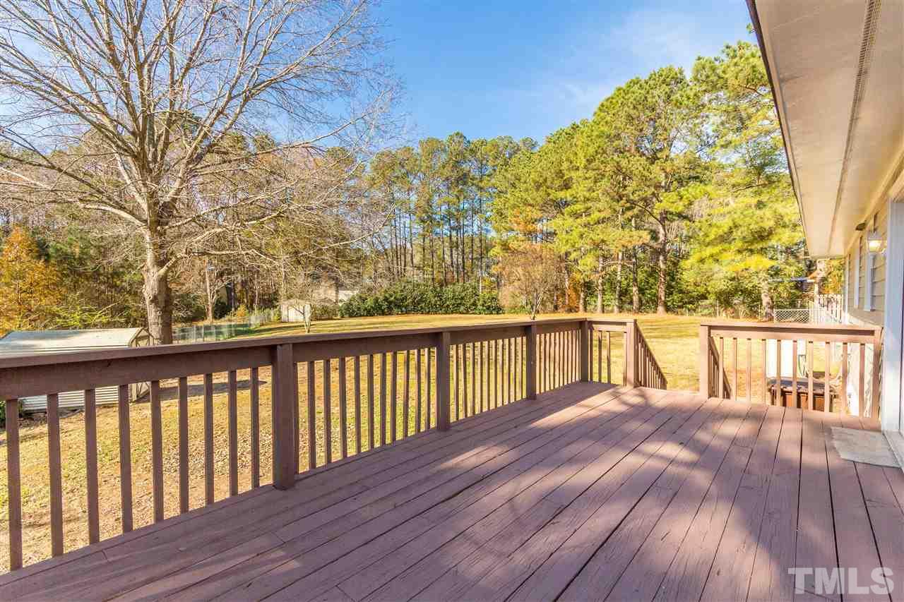 10616 Chelsea Drive Raleigh, NC 27603 - Photo 9 of 25 a balcony with wooden floor and trees