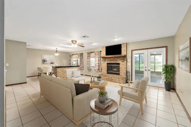 a view of an empty room with window and a fireplace