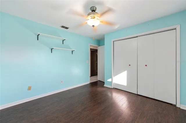 a bathroom with a granite countertop toilet sink and mirror