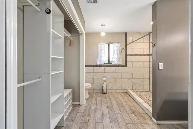 a bathroom with a sink shower and a mirror