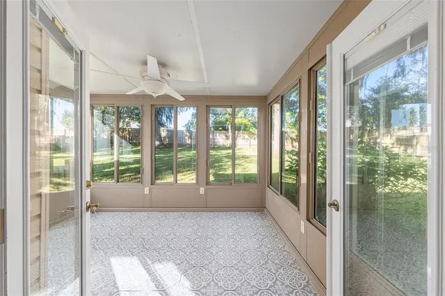 a view of an empty room with windows and balcony