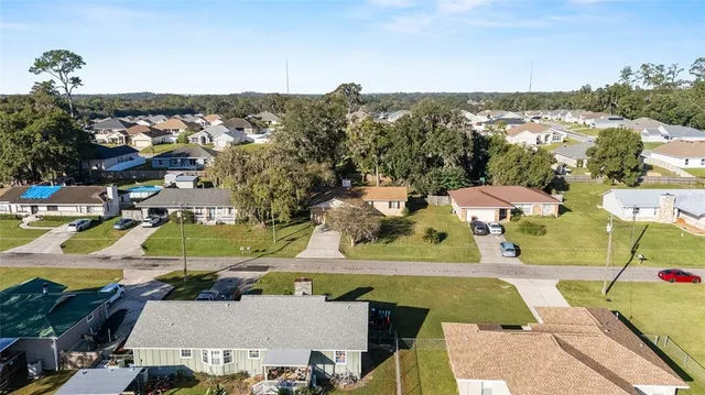 an aerial view of residential building with green space