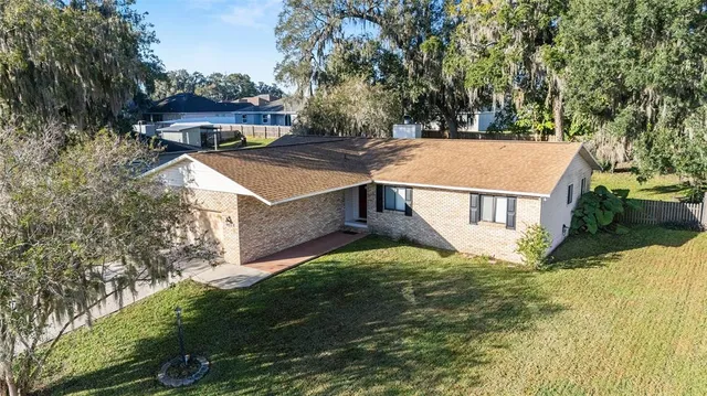 a view of a house with pool and a yard