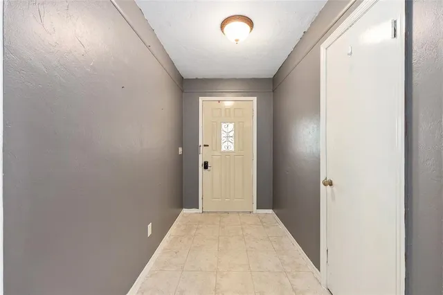 a view of an empty room and fire place