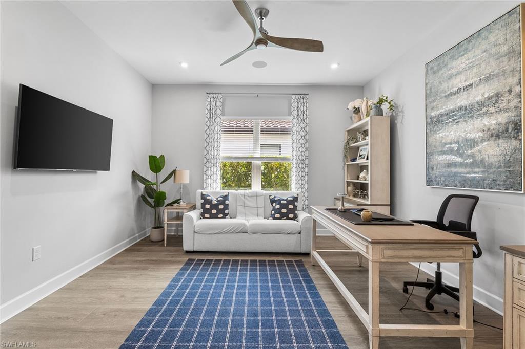 15345 Aprile Street Naples, FL 34114 - Photo 13 of 29 a living room with furniture and a flat screen tv