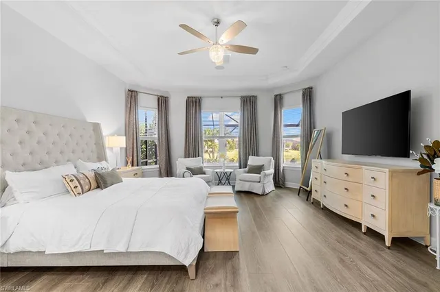 a bedroom with a bed and flat screen tv
