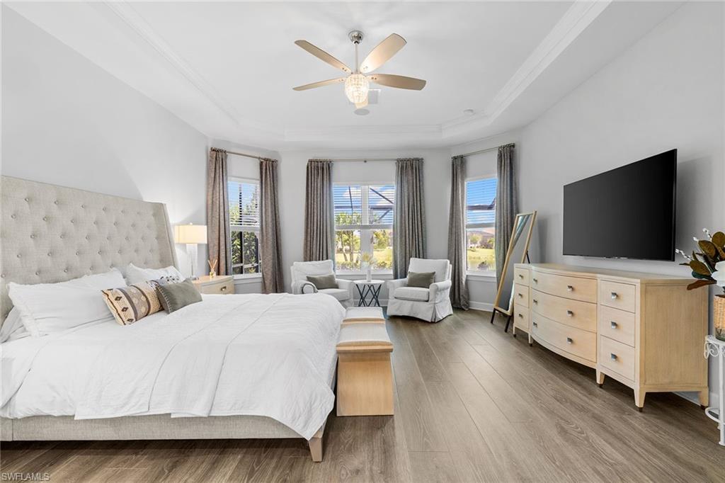 15345 Aprile Street Naples, FL 34114 - Photo 15 of 29 a bedroom with a bed and flat screen tv