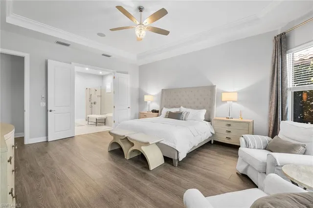 a spacious bedroom with a bed couch and window